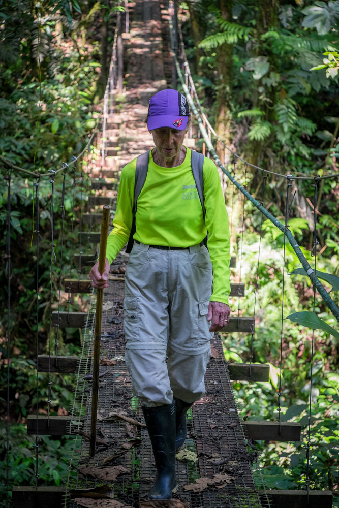 Ane crossing a suspension bridge in the Amazon rainforest